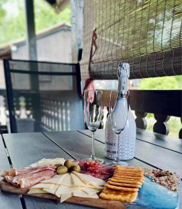 stół z talerzem jedzenia i butelką wina w obiekcie Schmelcer house in Terme Čatež w mieście Čatež ob Savi