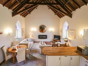 a living room with a couch and a table at Frogwell Chapel in Callington