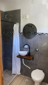 a bathroom with a sink and a toilet at Hostel Otto Tipp in El Bolsón