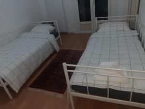 two beds sitting in a room with at Modern apartmen in Athina in Athens