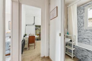 a room with a bed and a desk and a mirror at Wonderful apartment close Champs-Elysées in Paris
