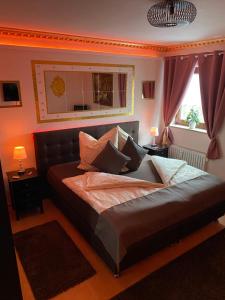 a bedroom with a bed with a couch and a window at Pension King Royal in Hamburg