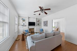 a living room with a couch and a ceiling fan at Large Groups Welcome - 2 Homes Next Door in New Iberia