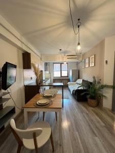 a living room with a table and a couch at Modern flat - apartament nou aproape de Spital și Aeroport in Iaşi