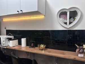a kitchen with a counter with a heart mirror at Român Holidays in Rome