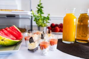 a table with several cups of fruit and juice at Hotel Duo Spa in Janów Lubelski