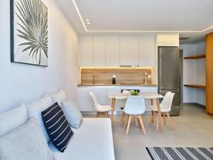 a living room with a white couch and a table at Sapphire apartment - Paros Gem in Naousa