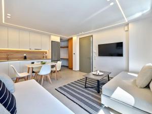 a living room with a white couch and a table at Sapphire apartment - Paros Gem in Naousa