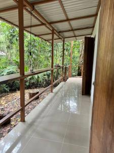 an empty porch of a house with a wooden ceiling at Comfy jungle place / FiberOptic/1 km from the beach in Cocles
