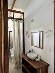 a bathroom with a sink and a toilet and a mirror at Comfy jungle place / FiberOptic/1 km from the beach in Cocles