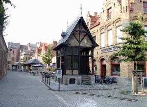 a small building on a street in a city at Sweet inn in Ypres