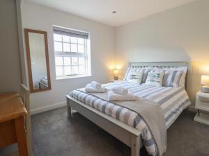 a bedroom with a bed with towels on it at Harbour View in Porthmadog