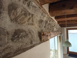 a stone wall in a room with a window at Appartement Fassbinder in Hall in Tirol