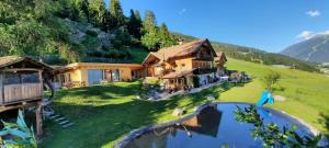 a house in the mountains with a swimming pool at Chalet Panorama Himmelreich in San Candido