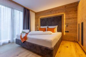 a bedroom with a large bed and a large window at Chalet Panorama Himmelreich in San Candido