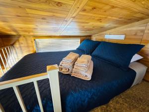 a bed in a cabin with two pillows on it at Cozy 1BR Cabin in Jacksonville in Jacksonville