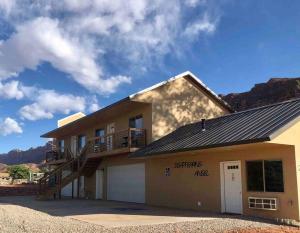 a house with a balcony and a garage at Angel Rock Rentals of Moab Unit 2 in Moab