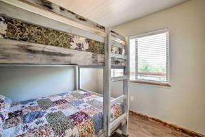 a bedroom with a bunk bed and a window at Angel Rock Rentals of Moab Unit 2 in Moab