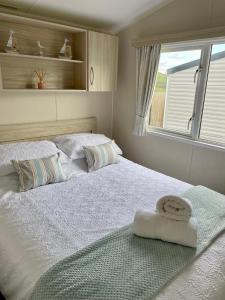 1 dormitorio con 2 camas y toallas. en Newquay Bay Resort Sandy Toes - Hosting up to 6, en Newquay