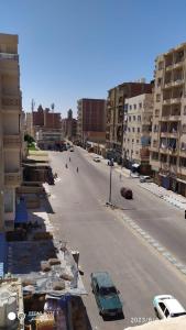an empty street with cars parked in a city at Luxry flat in matrouh in Marsa Matruh