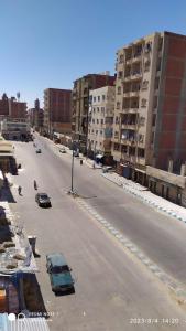 uma rua urbana vazia com carros e edifícios em Luxry flat in matrouh em Marsa Matruh