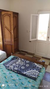 a bedroom with a bed and a window and a door at Luxry flat in matrouh in Marsa Matruh