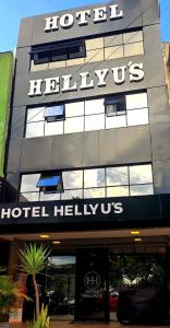 a hilton hotel with a sign on top of it at Hotel Hellyus in Brasilia