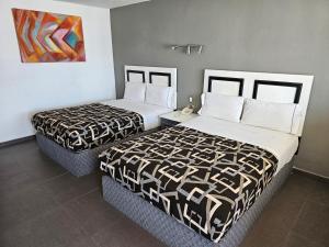 Postel nebo postele na pokoji v ubytování LaVid Aguascalientes + 10 fotografií