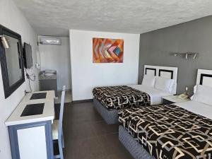 Postel nebo postele na pokoji v ubytování LaVid Aguascalientes