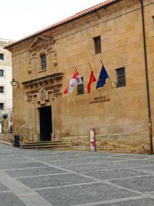a building with flags on the side of it at A orillas del Duero in Soria