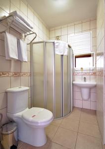 a bathroom with a toilet and a shower and a sink at Grand Eyuboglu Hotel in Istanbul