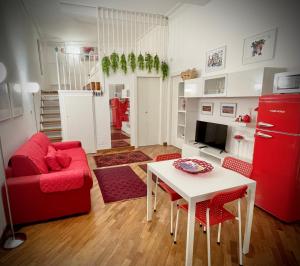 a living room with a red couch and a table at Casa Ina Palermo in Palermo