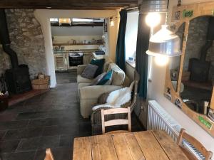 a living room with a couch and a table at The Old Coop Barn in Brassington