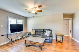 a living room with a couch and a tv at Spacious Orange Rental about 3 Mi to Museums and Garden! in Orange