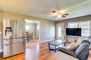 a living room with a couch and a refrigerator at Spacious Orange Rental about 3 Mi to Museums and Garden! in Orange