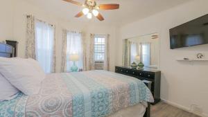 a bedroom with a bed and a ceiling fan at Escape to Raleigh Ave - Steps from the Beach in Atlantic City