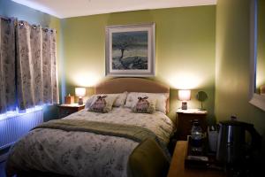 a bedroom with a bed with two lamps and a picture on the wall at Meadowsweet House in Stockton-on-Tees