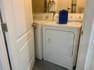a white washer and dryer in a small kitchen at 2 bedroom basement with private entrance in Guelph