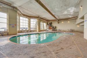 a swimming pool in a large room with windows at Waterfront Two Harbors Condo with Indoor Pool Access in Two Harbors