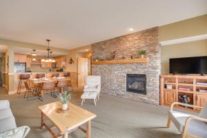 a living room with a table and a fireplace at Waterfront Two Harbors Condo with Indoor Pool Access in Two Harbors