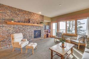 a living room with a brick wall and a fireplace at Waterfront Two Harbors Condo with Indoor Pool Access in Two Harbors