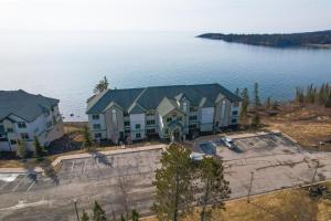 an aerial view of a house by the water at Waterfront Two Harbors Condo with Indoor Pool Access in Two Harbors