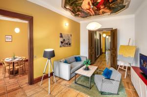 a living room with a couch and a table at Art House Apartments by Adrez in Prague