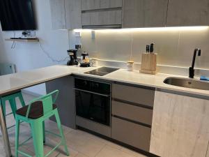 a kitchen with a sink and a stove at Departamento Estudio, centrico in Temuco