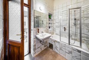 a bathroom with a sink and a tub and a shower at Art House Apartments by Adrez in Prague +19 photos