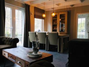 a living room with a table and some chairs at vakantiewoning Charme Bohan Sur Semois in Vresse-sur-Semois