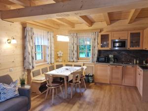 a kitchen and dining room with a table and chairs at Romantik Chalet Pretalhof in Turnau
