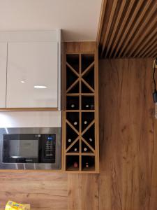 a kitchen with a cabinet filled with wine bottles at Mountain Oasis Bjelasnica in Bjelašnica