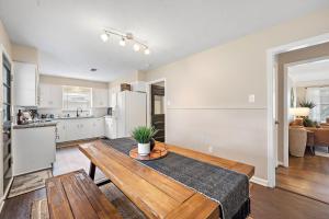 a kitchen and living room with a wooden table at with Arcade and Covered Patio Sleep 9 in this 4 Bedroom 2 Bath Home 5 star host Deer Park TX in Deer Park