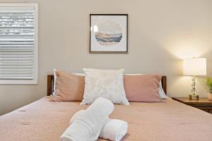 a bed with a teddy bear laying on top of it at with Arcade and Covered Patio Sleep 9 in this 4 Bedroom 2 Bath Home 5 star host Deer Park TX in Deer Park